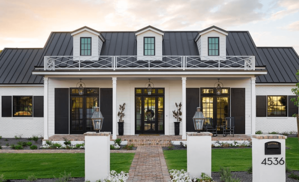 white  metal building homes with a black roof 