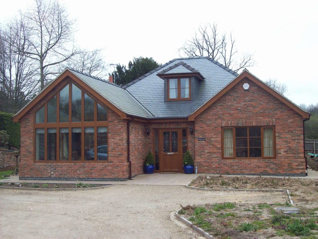 A large brick house with a metal roof
