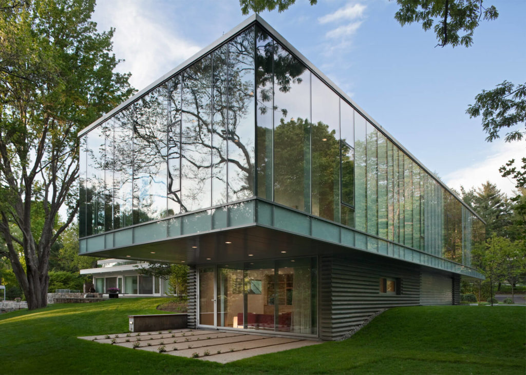 Glass House Architecture with a staircase leading to it 