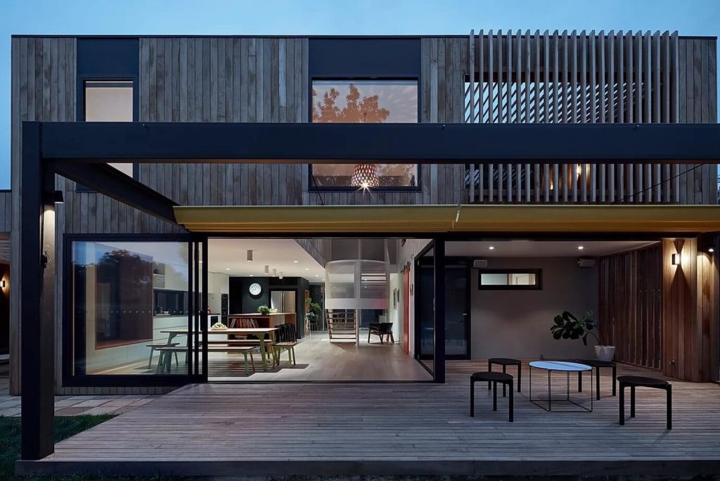 House 108 with a wooden deck and glass doors 