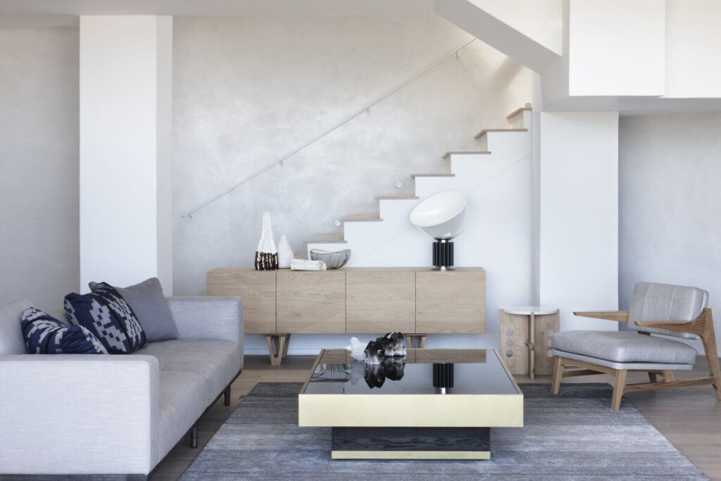 La Belle Vue living room filled with furniture and a stair case
