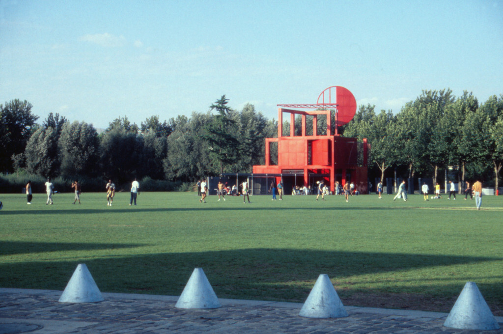 A group of people standing on top of a lush green field
