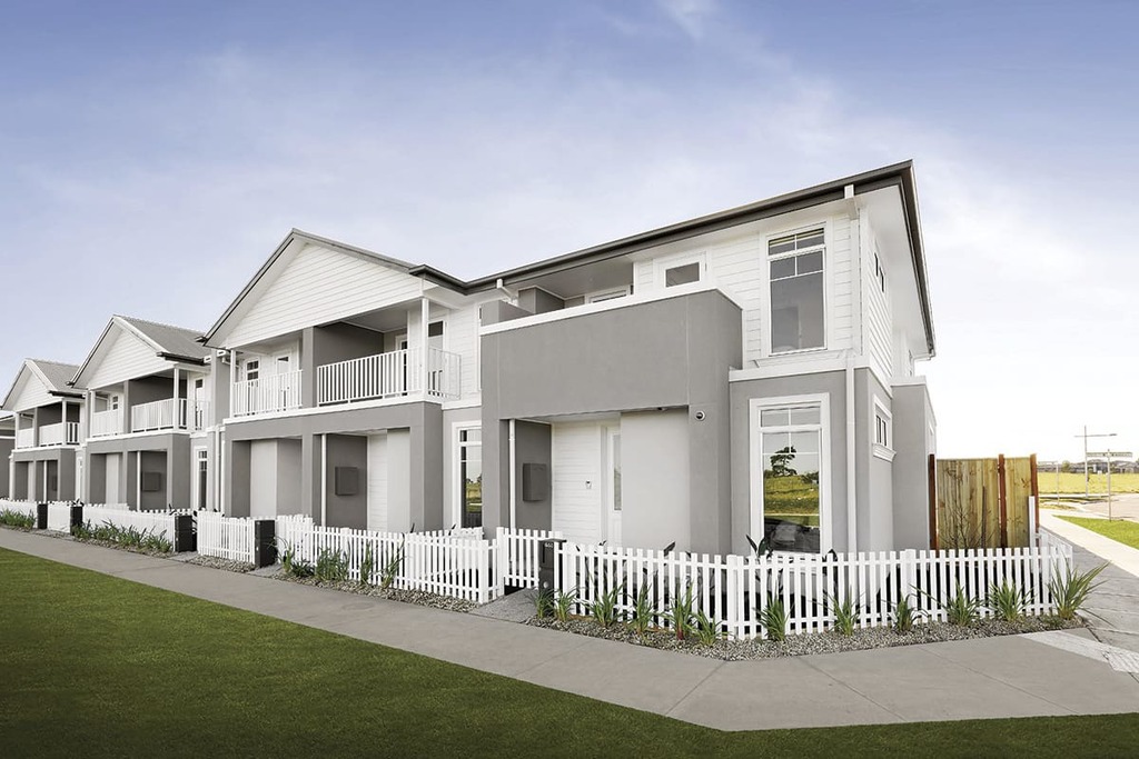 A row of houses with a white picket fence modern townhouse design 