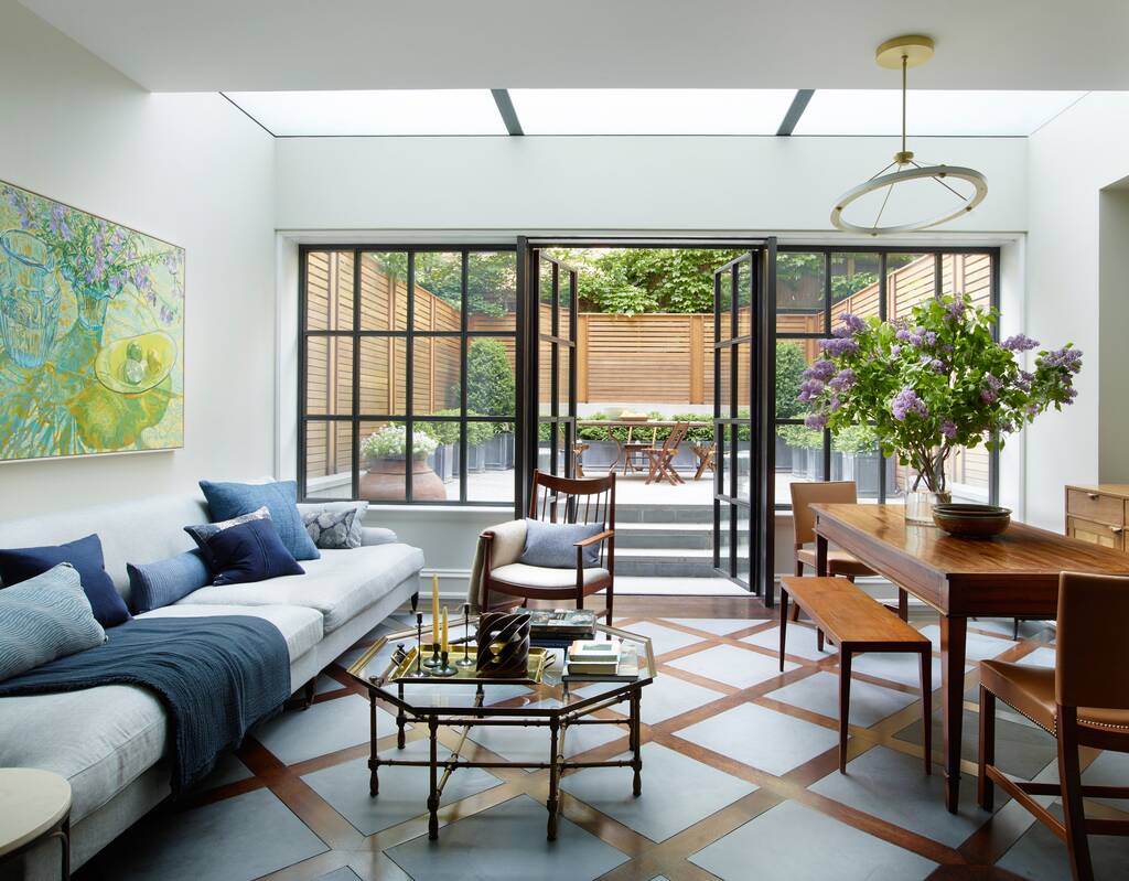 modern townhouse living room filled with furniture and a large window
