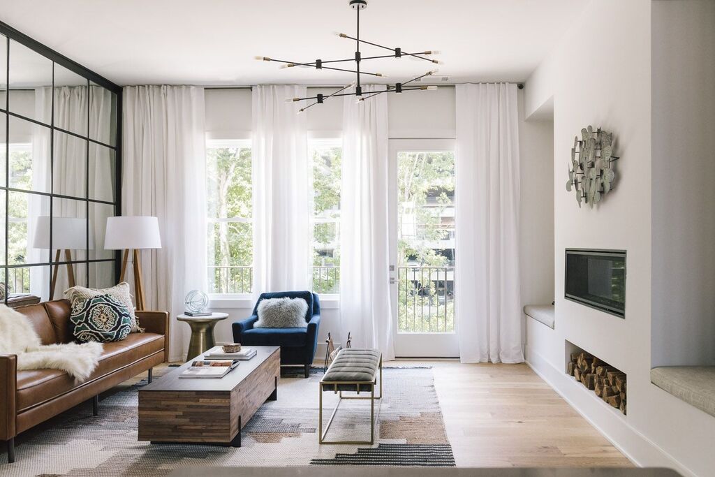 modern townhouse  living room filled with furniture and a fire place
