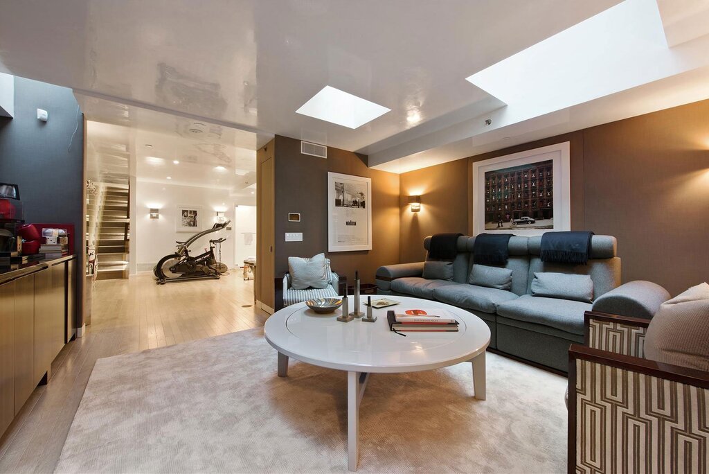 modern townhouse living room with furniture and a skylight 