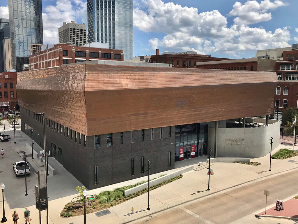 dallas holocaust museum with a brown roof on a city street