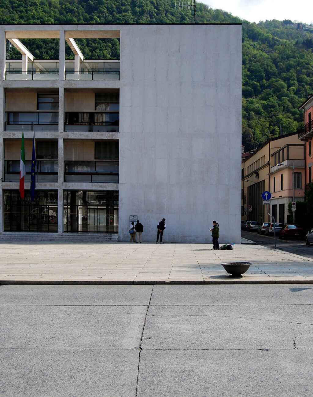 Two people standing in front of acasa del fascio
