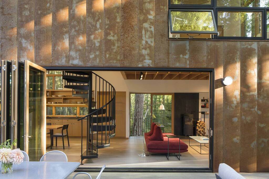 A living room with a red chair and a staircase
