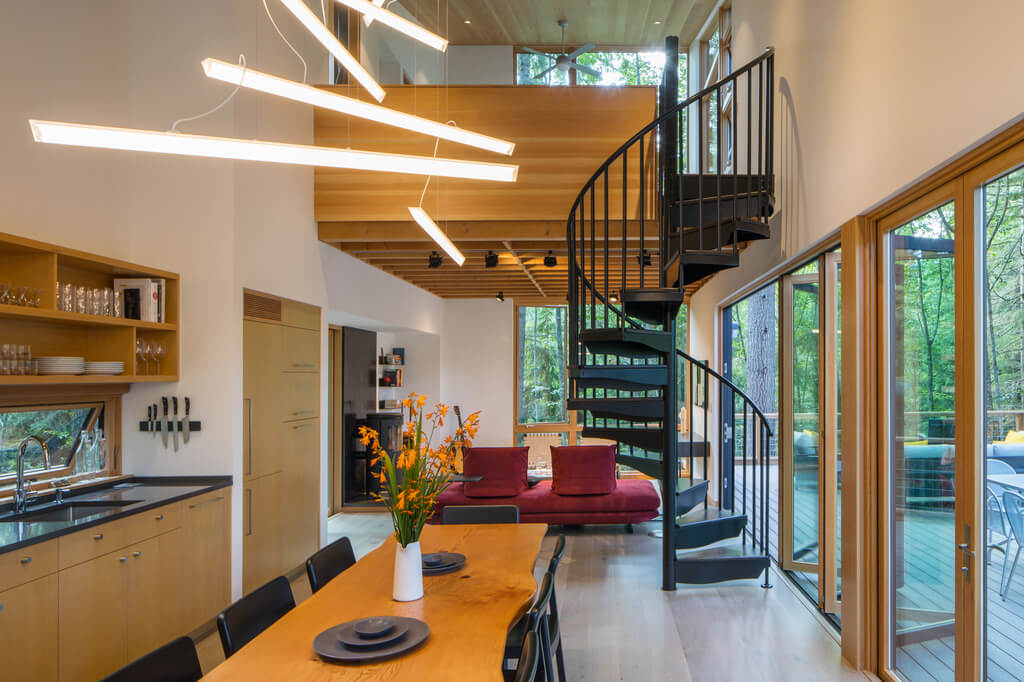 Little House Big Shed living room filled with furniture and a spiral staircase 