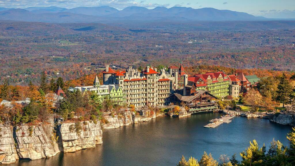 An aerial view of a resort surrounded by mountains
