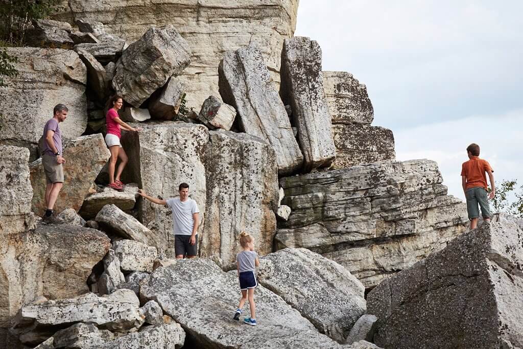 A group of people standing on top of large rocks
