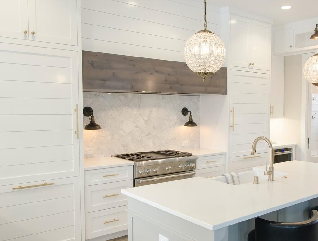 A kitchen with a stove top oven and a sink
