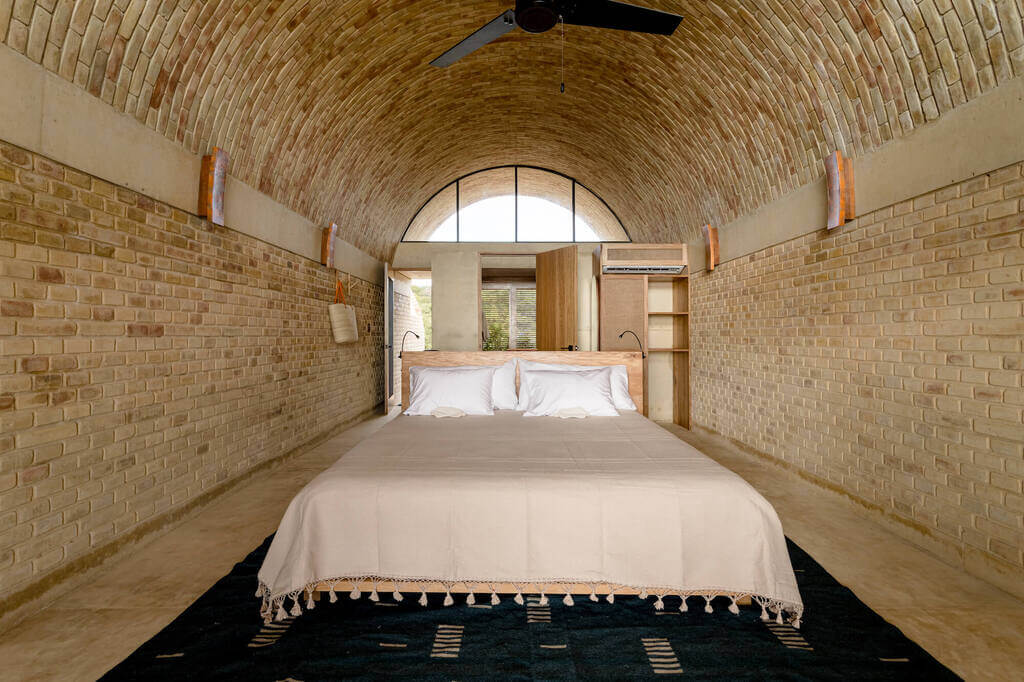 A bedroom with a bed and a ceiling fan
