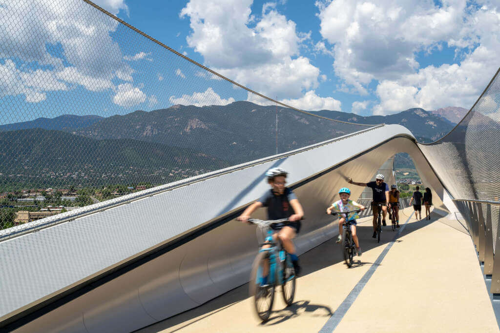 A group of people riding bikes on Park Union Bridge