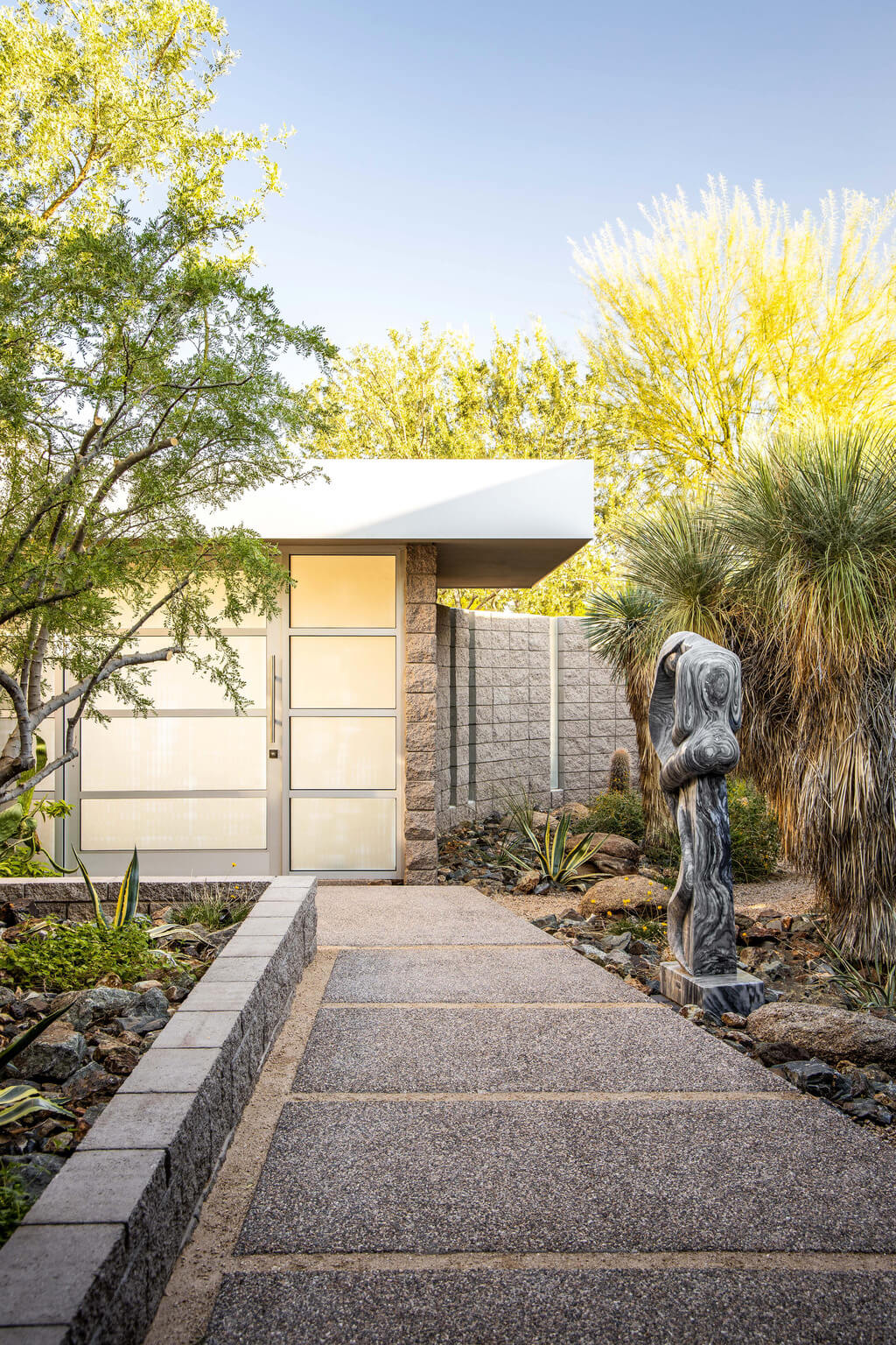 Echo Canyon Residence walkway leading to a house with a statue in front of it
