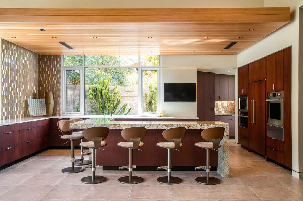 Echo Canyon Residence kitchen with a center island with four stools 