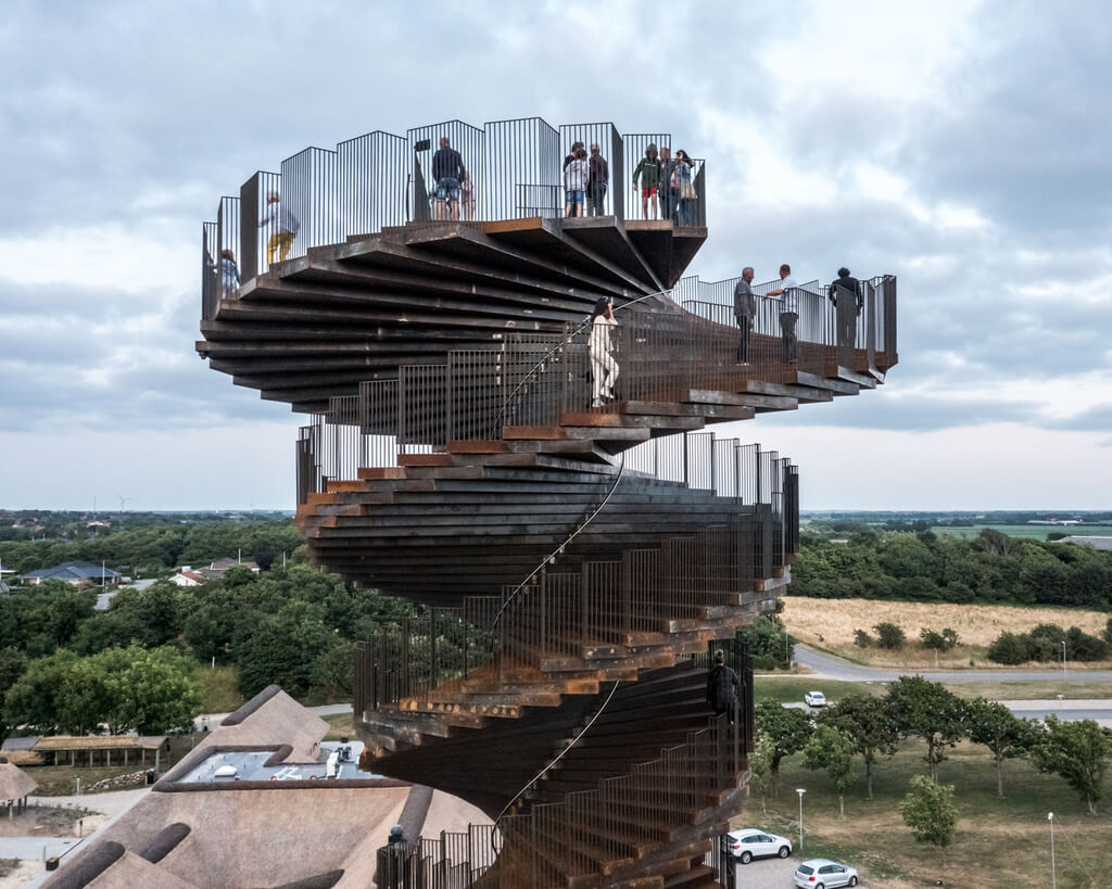 A group of people standing on top of marsk tower by bjarke ingels group's