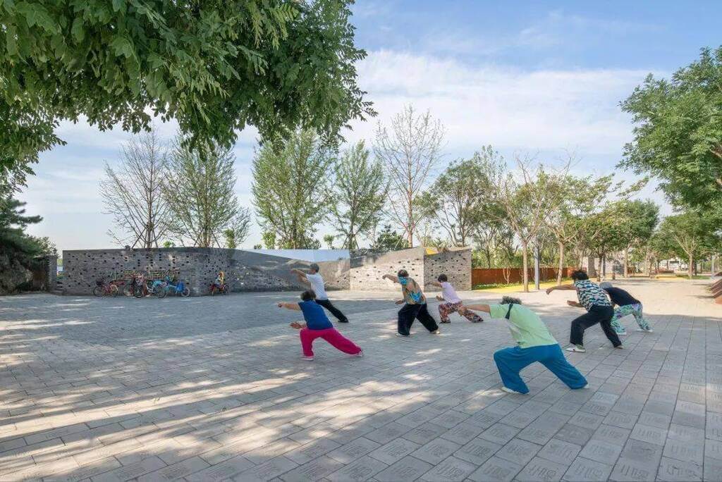 people doing yoga songzhuang micro community park by crossboundaries