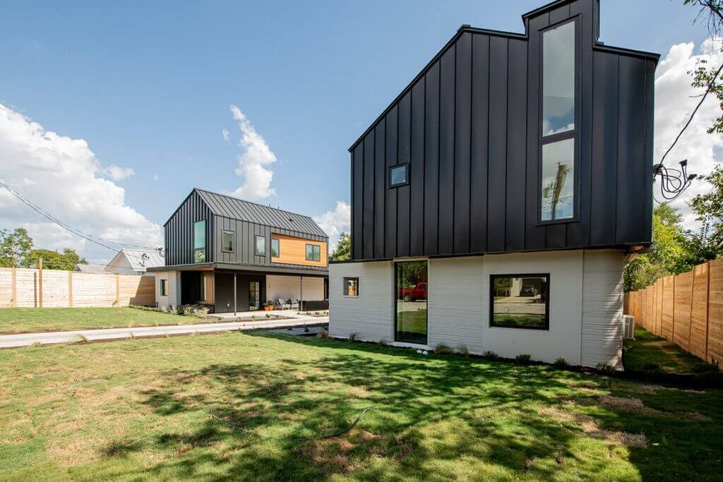 A house with a black roof and white walls
