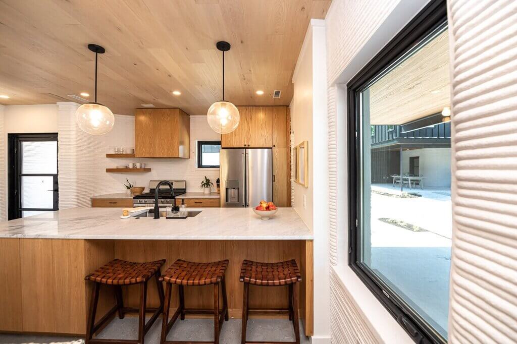 A kitchen with a lot of counter space and stools
