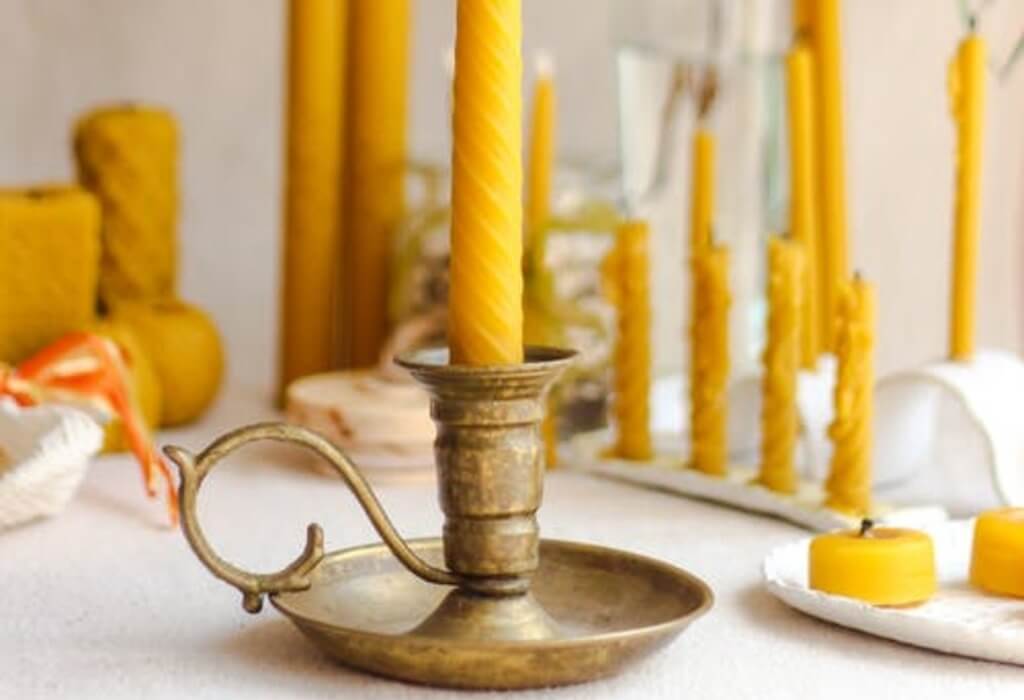 vibrant yellow candles with holding stand