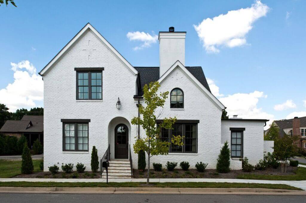 Traditional White Brick House with Black Trim