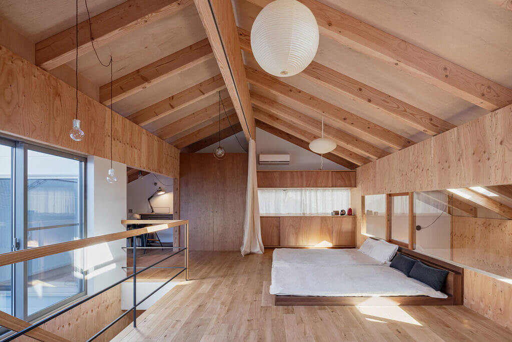 Imaise house bedroom with wooden walls and a white bed
