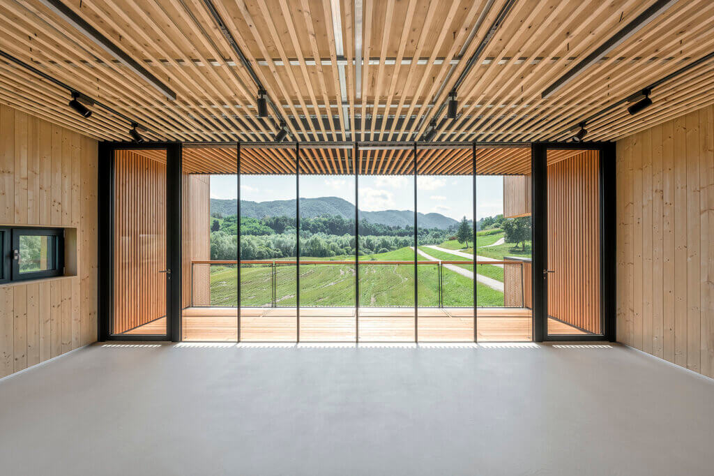 A room with a large window and a wooden ceiling of Beaver Center 