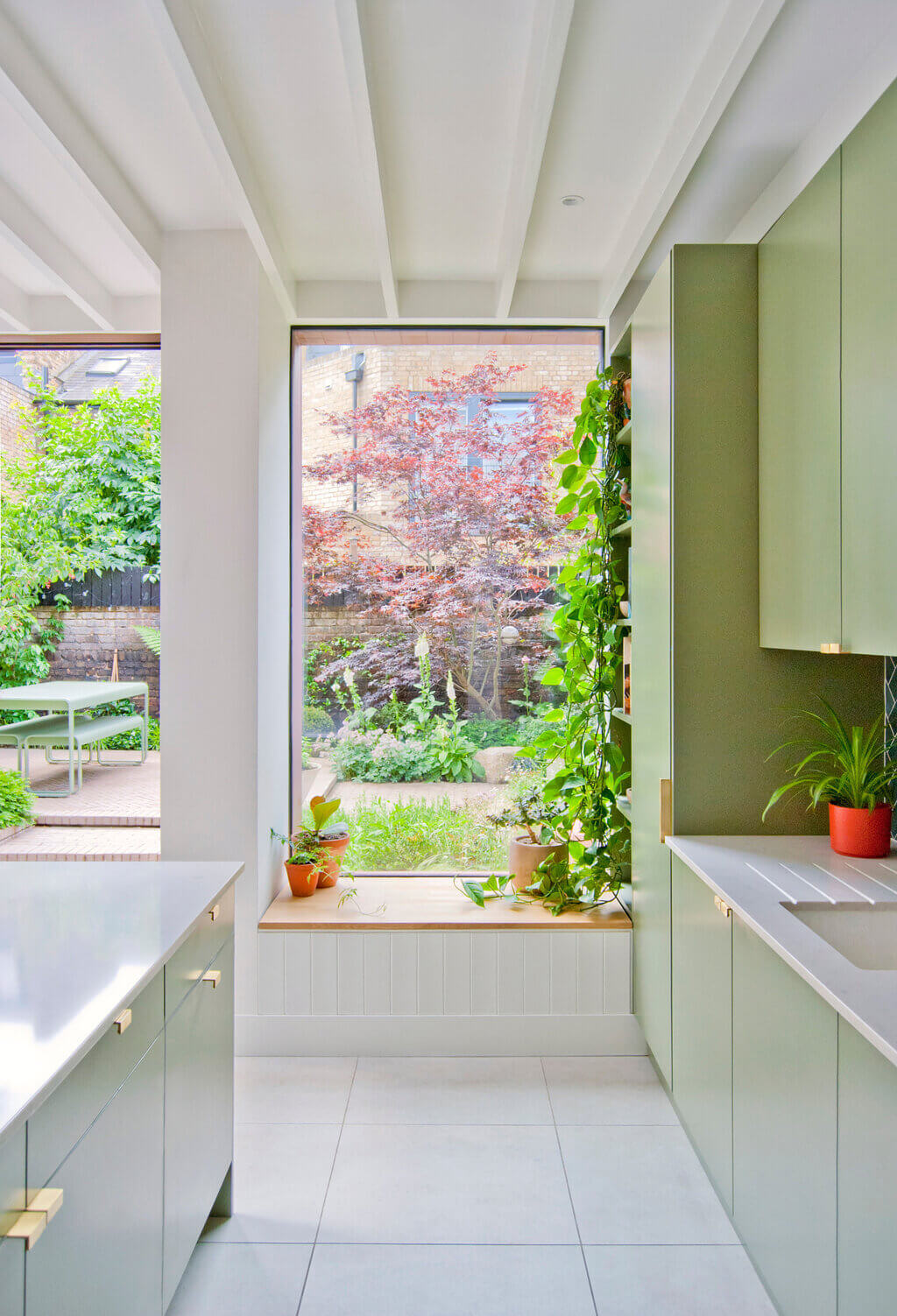 Bracken House  kitchen with a large window and potted plants

