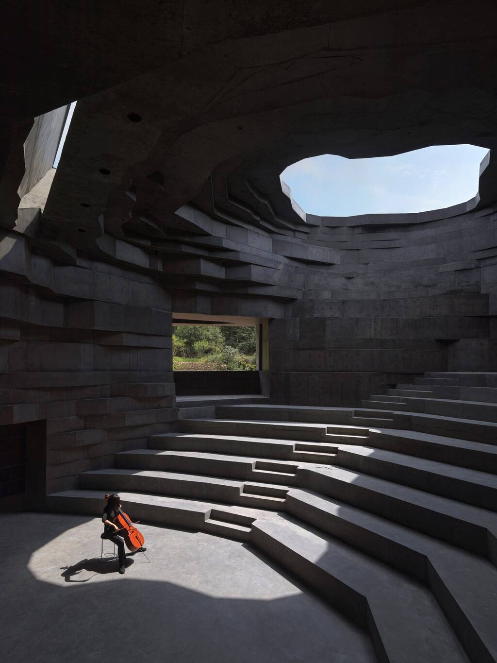 A person sitting on the floor of Chapel of Sound Amphitheatre