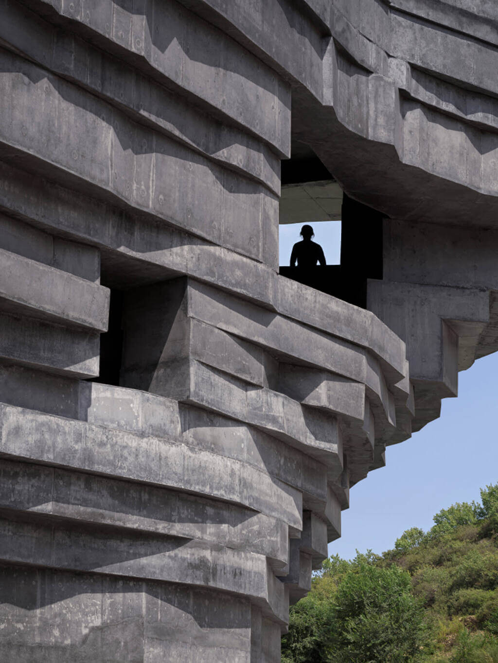 A man standing in a window of Chapel of Sound Amphitheatre