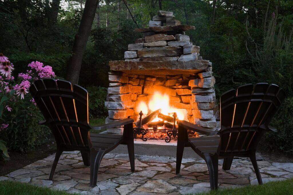 Two chairs sitting in front of a Outdoor 
fire pit
