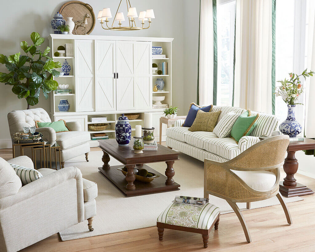 A living room with sofa , center table and a large window
