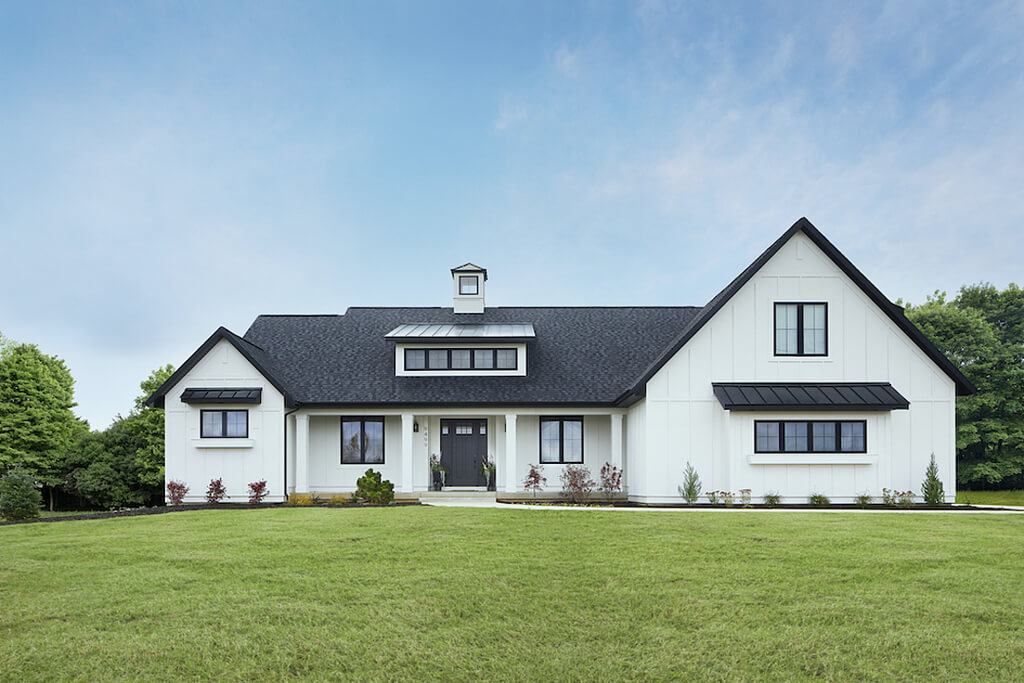 A large white house with a black roof
