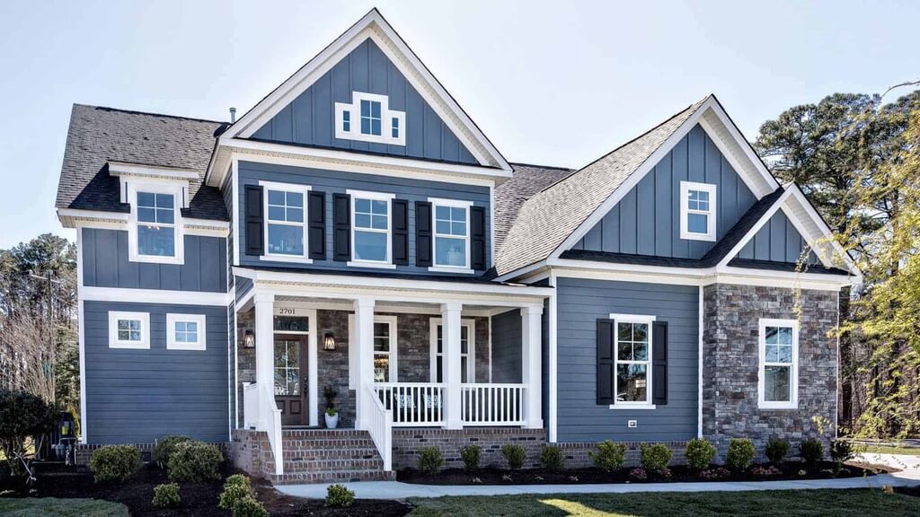 A blue house with white trim and windows
