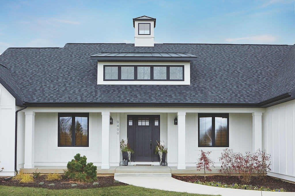 A white house with a black front door
