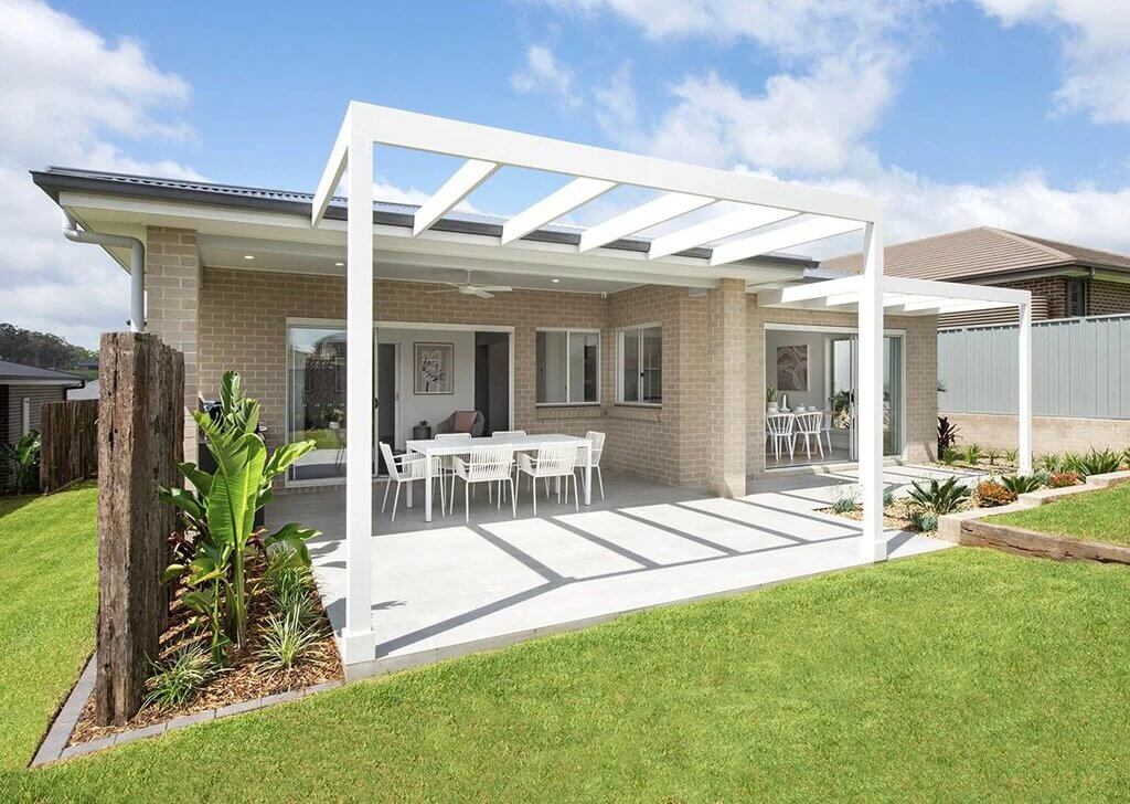 A patio with a table and chairs in it
