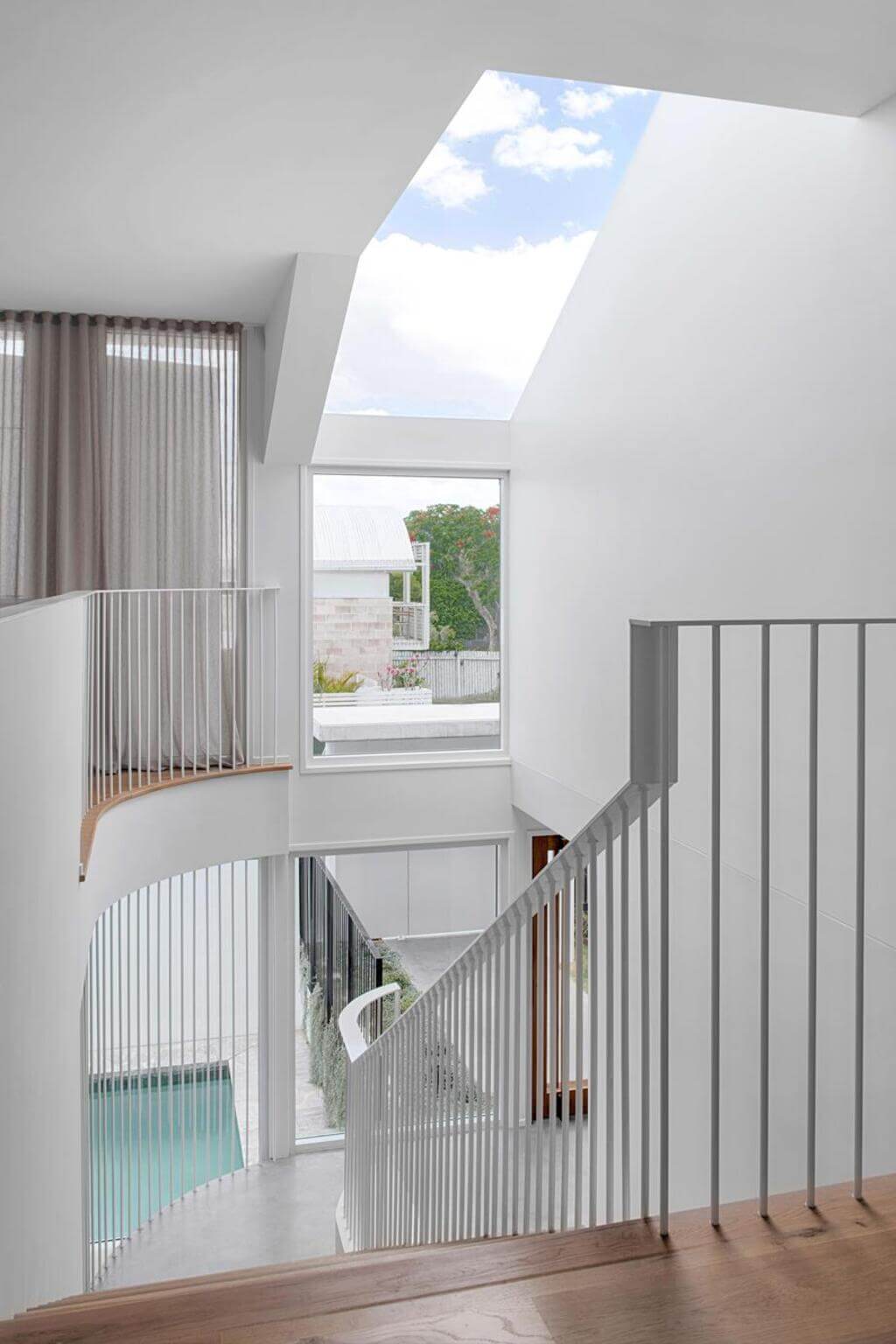 A Brisbane Queenslander Home staircase leading to a second floor with a skylight