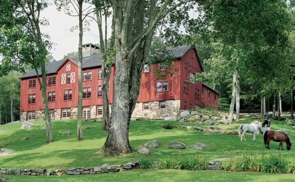 modern barn style house and two horses