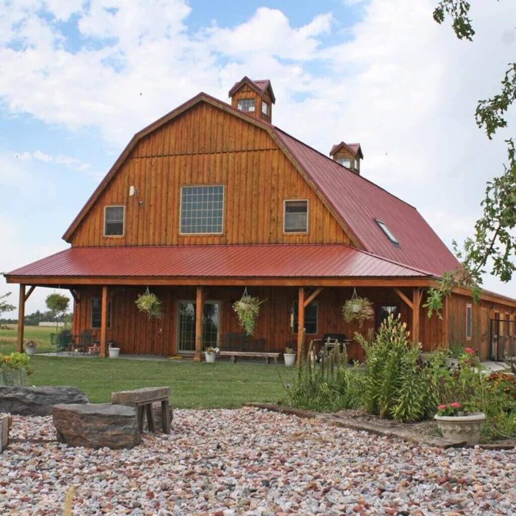 large barn style home with red roof