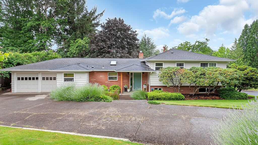 rambler homes ranch style house with a driveway in front of it 