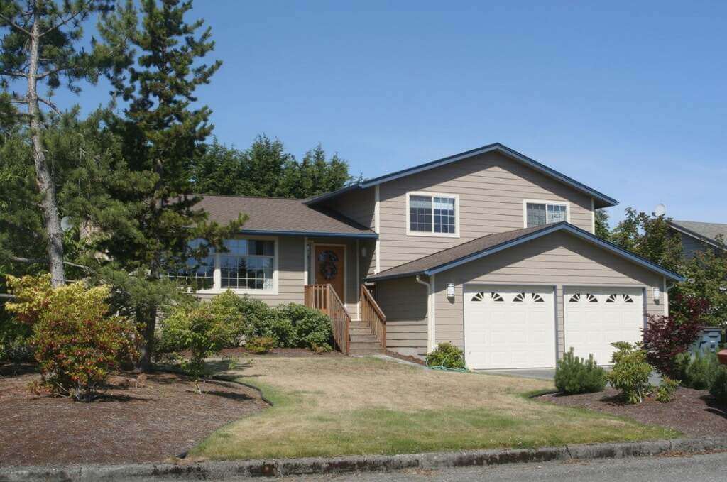 rench house with a driveway in front of it 