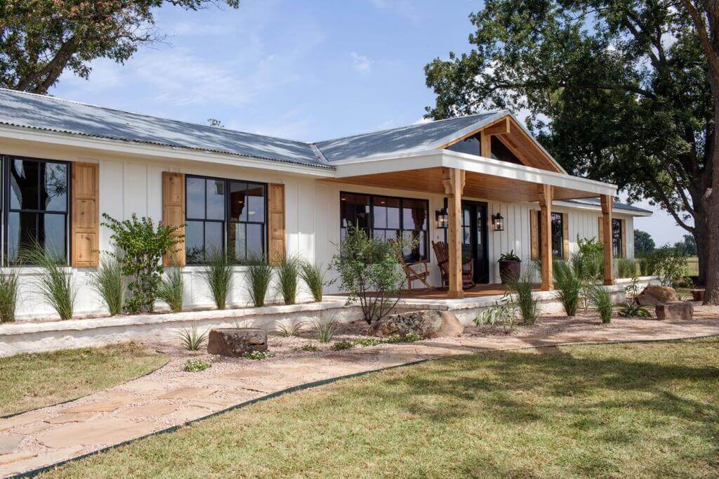 A white house with wooden shutters and windows
