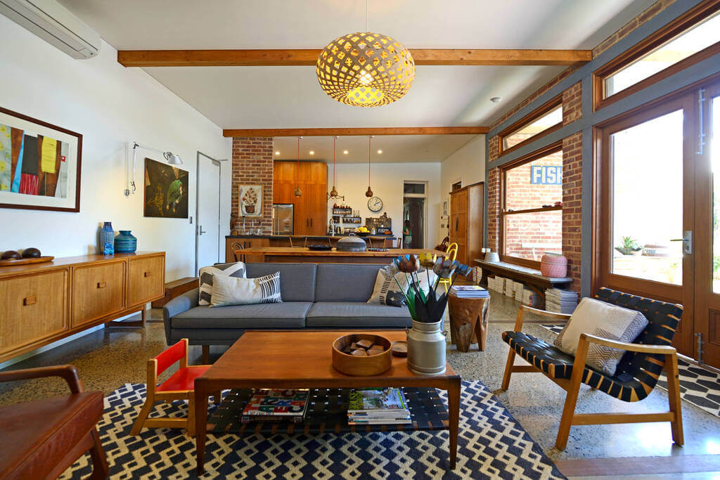 A living room filled with furniture and lots of windows
