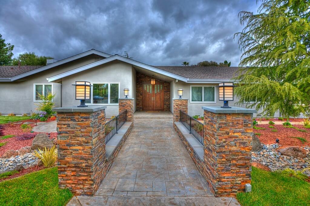 A house with a stone walkway leading to the front door
