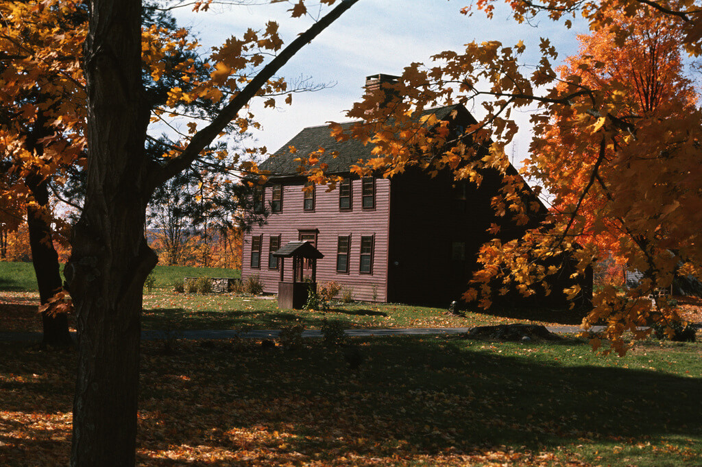 salt box house surrounded by trees in the fall