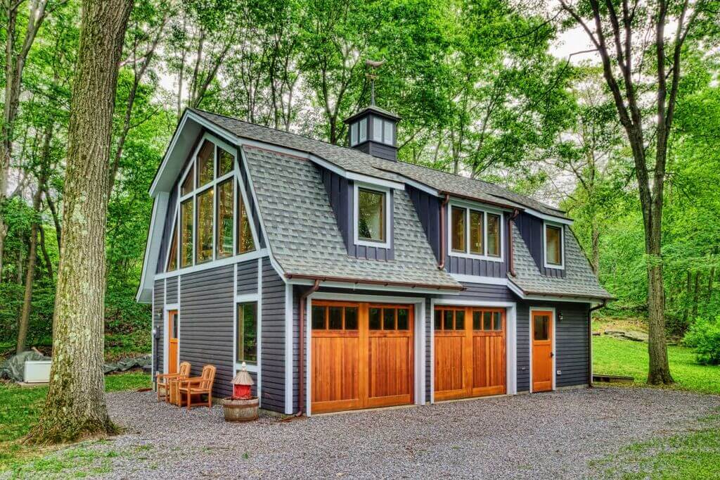 barn style house with gray color exterior and big glass windows