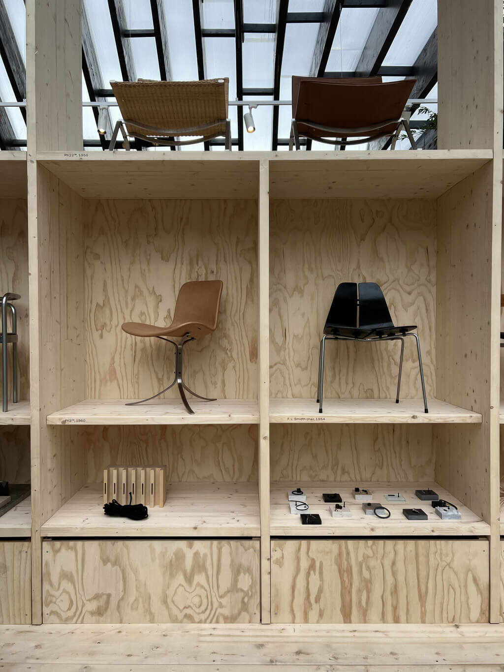 Fritz Hansen Pavilion wooden shelf filled with lots of furniture
