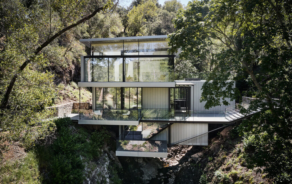 Suspension House on a cliff overlooking a river
